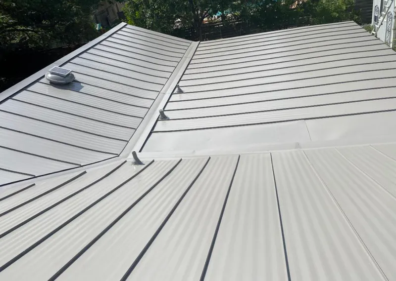 Solar attic fan installed on a metal roof for Roof Ventilation in Ghent